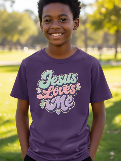 Boy wearing a purple t-shirt with the text "Jesus Loves Me" in pastel colors.