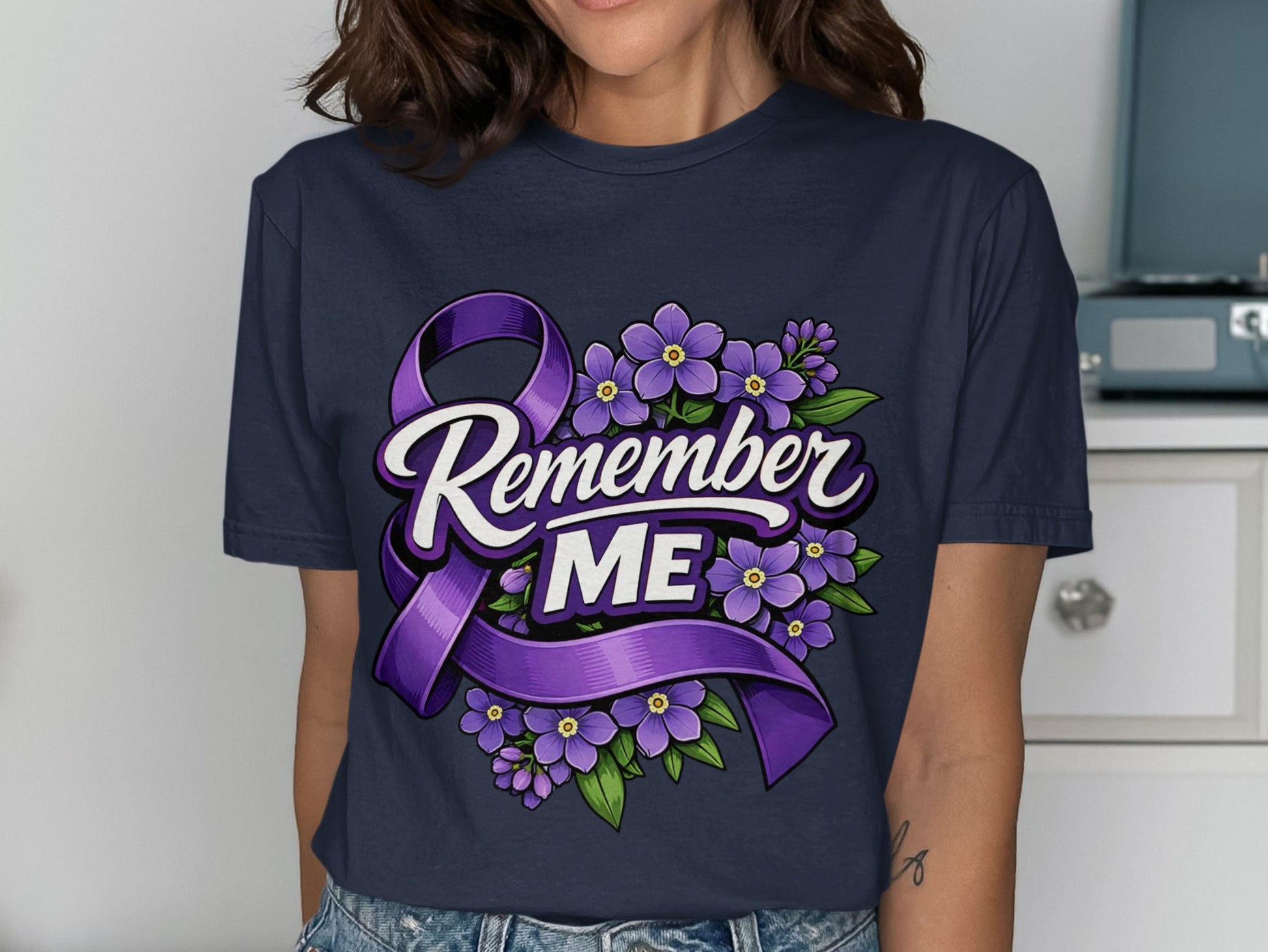 Dark blue t-shirt with purple ribbon and purple flowers, reads "Remember ME".