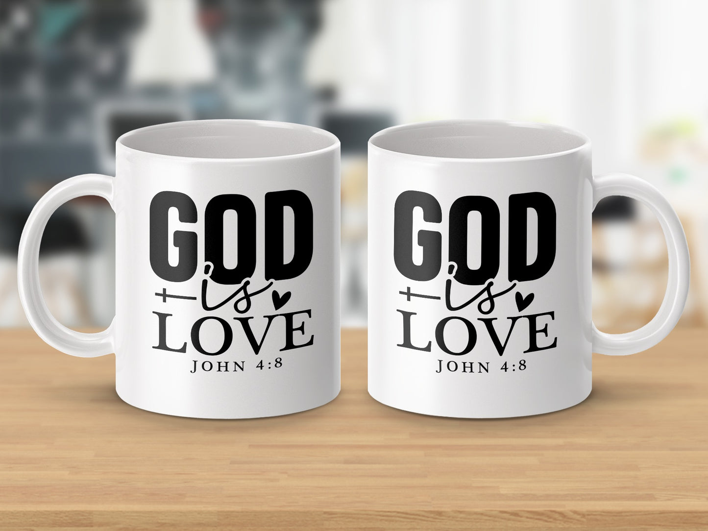 Two white mugs with black text "GOD IS LOVE" and "JOHN 4:8" printed on them.