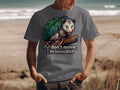 T-shirt graphic of opossum hiding behind leaf with text "If I don't move, I'm invisible."