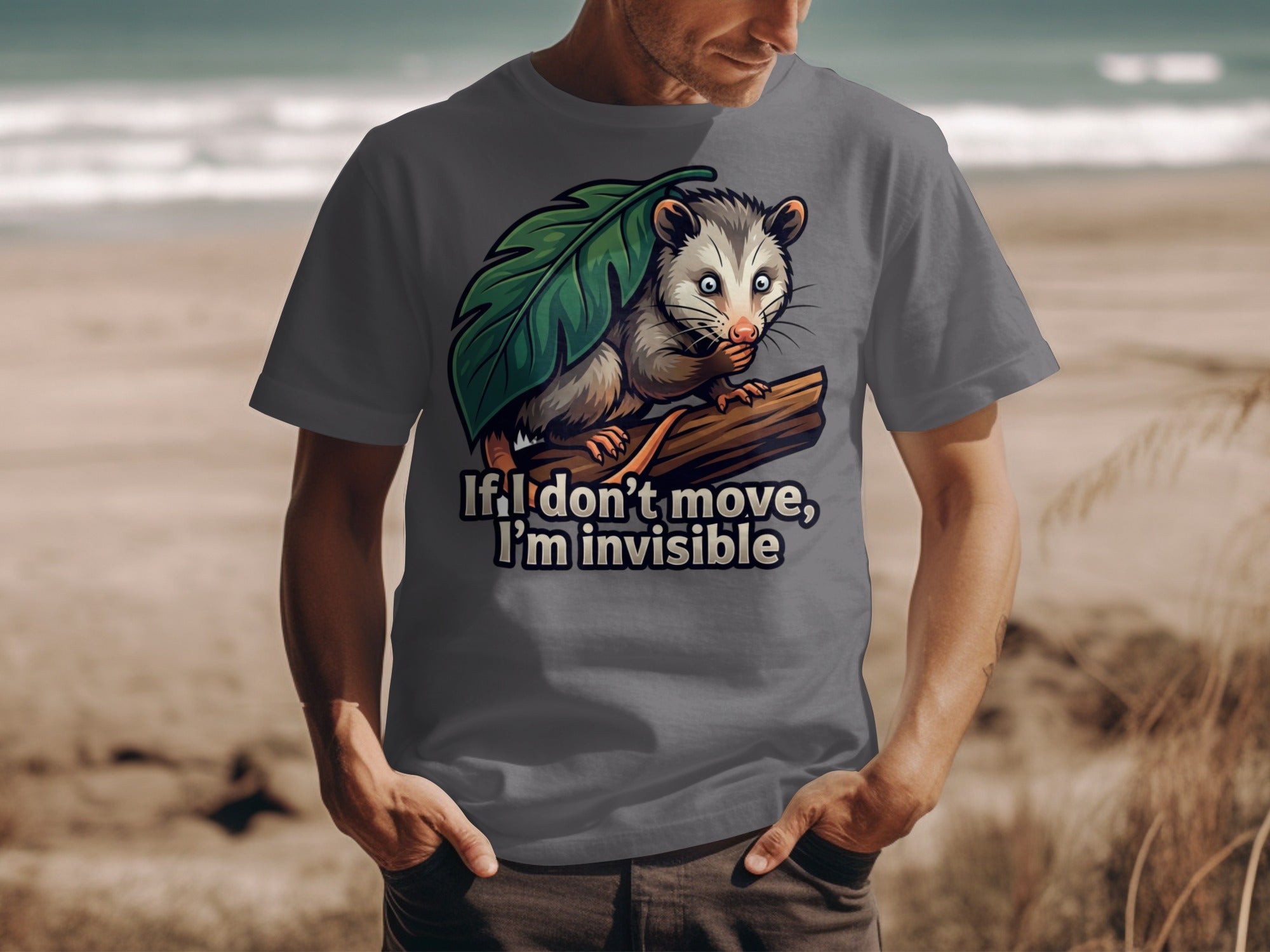 T-shirt graphic of opossum hiding behind leaf with text "If I don't move, I'm invisible."