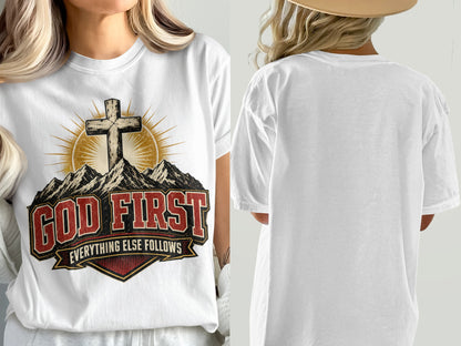 White t-shirt with a cross, mountains, and "GOD FIRST EVERYTHING ELSE FOLLOWS" text.