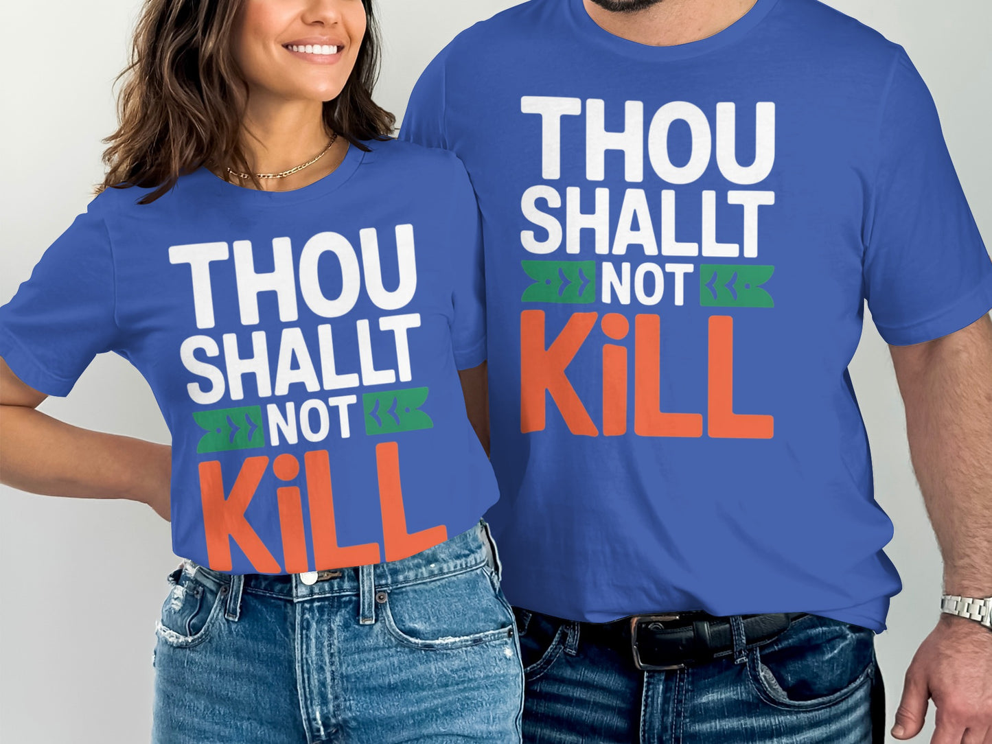 Two people wear blue shirts with "THOU SHALT NOT KILL" text in white, green, and orange.