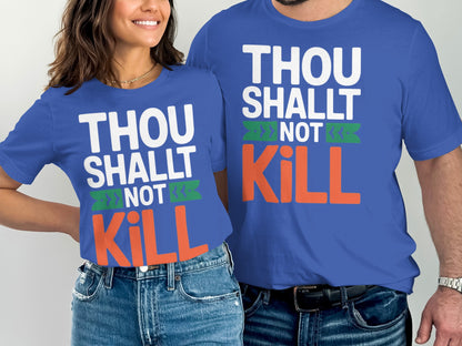 Two people wear blue shirts with "THOU SHALT NOT KILL" text in white, green, and orange.
