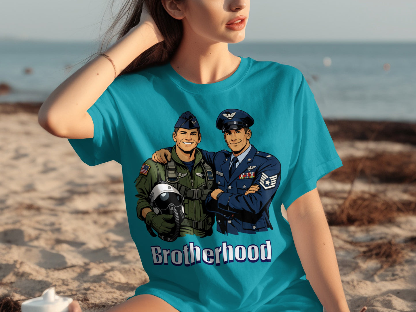 Teal t-shirt graphic of two smiling airmen in uniform; text reads "Brotherhood."