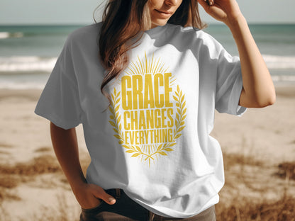 White t-shirt on a person with yellow text that reads "GRACE CHANGES EVERYTHING!".