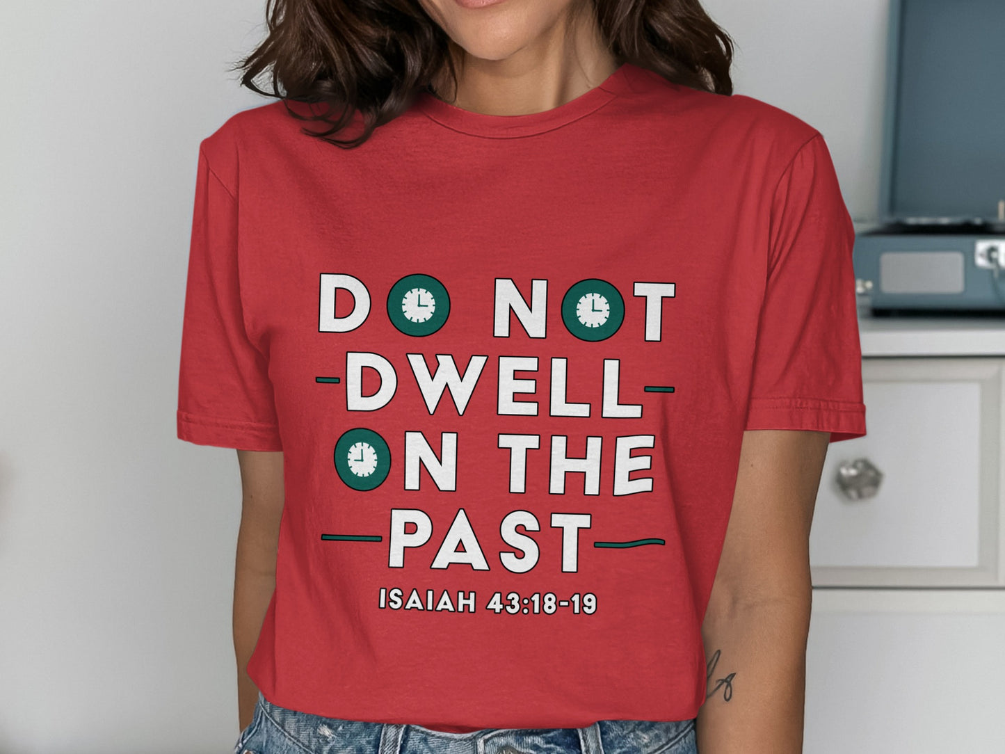 Red t-shirt with "DO NOT DWELL ON THE PAST" and Isaiah 43:18-19.