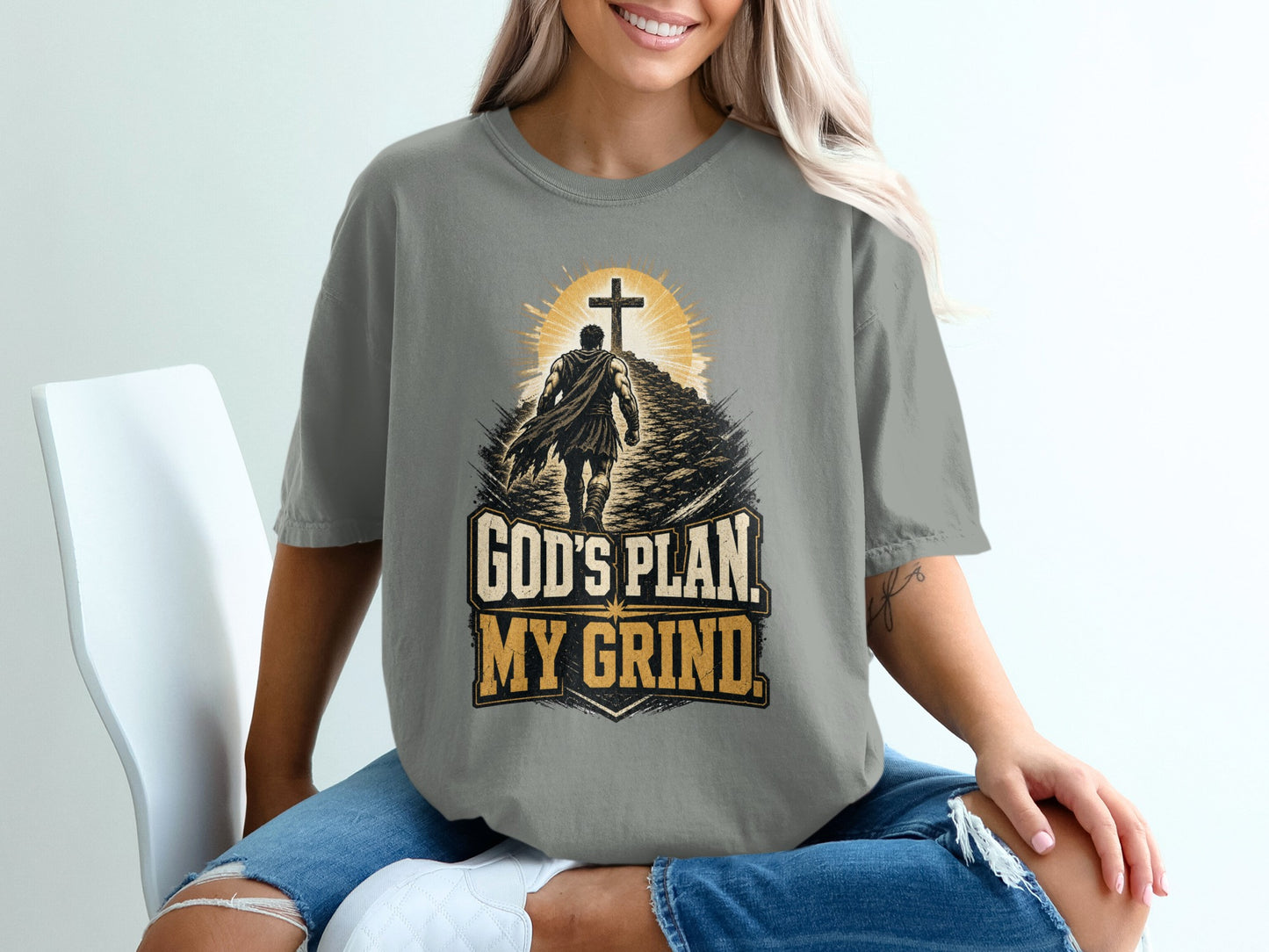 T-shirt graphic with man walking towards cross and text "GOD'S PLAN. MY GRIND."