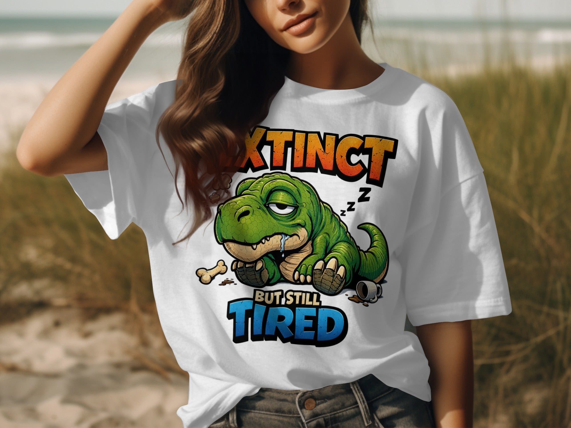 White t-shirt with cartoon dinosaur graphic reading "Extinct But Still Tired."