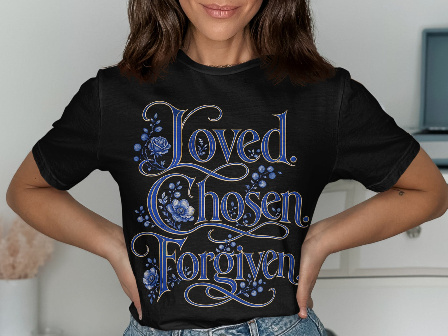 Black t-shirt with "Loved, Chosen, Forgiven" in blue script and floral design.