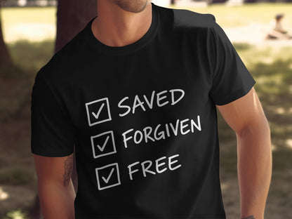 Black t-shirt with white text: Saved, Forgiven, Free, each with a checked box.