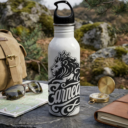 White water bottle with black lion crown and text "Earned" on outdoor table.