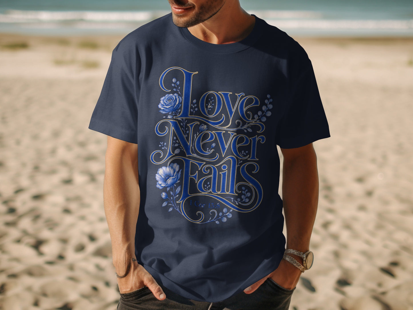 Navy t-shirt with "Love Never Fails" and 1 Cor 13:8 text with floral design.