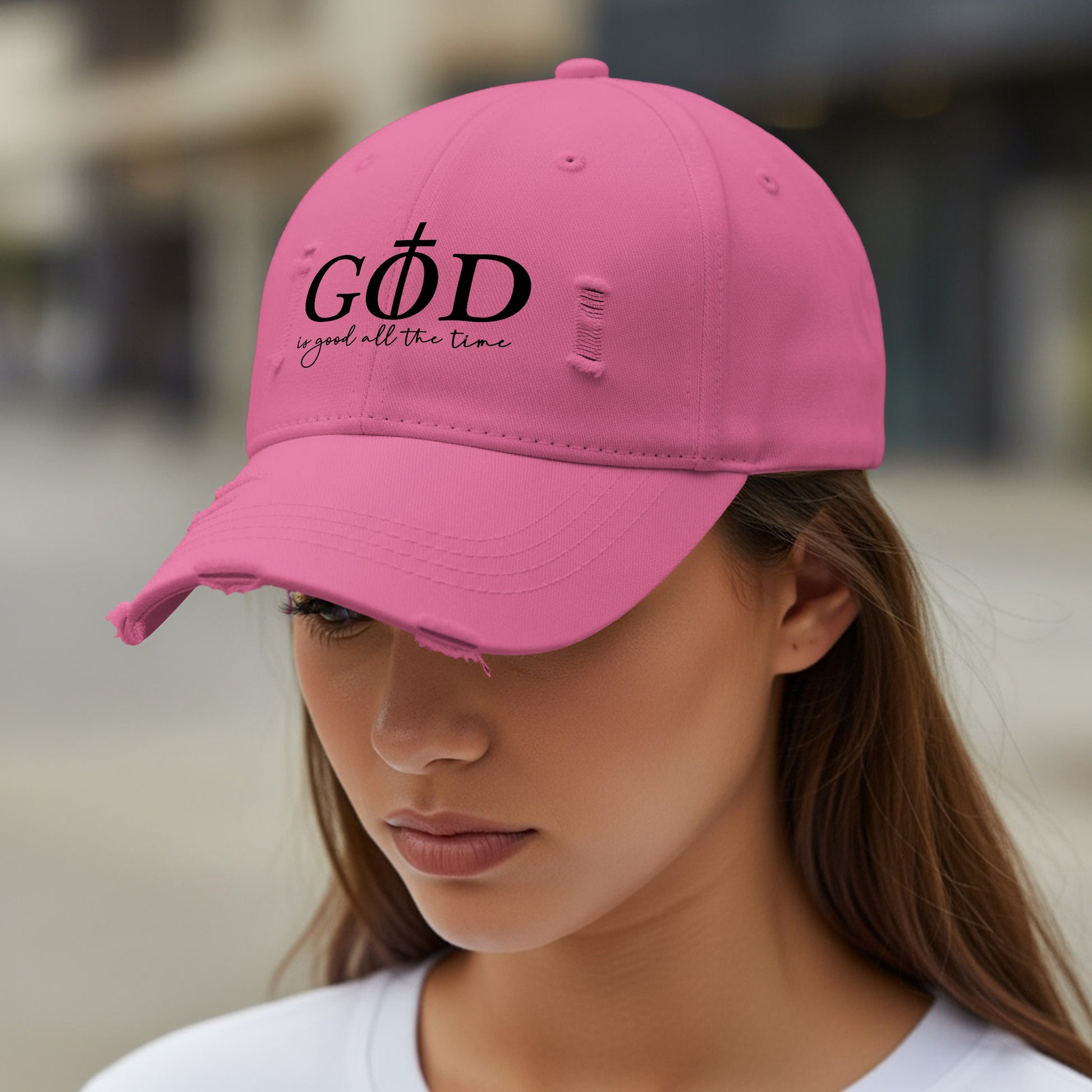 Pink distressed baseball cap with "GOD is good all the time" text.