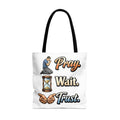 Tote bag with a man praying, hourglass, hands, and text "Pray. Wait. Trust."