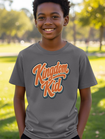 Boy wearing a gray t-shirt with "Kingdom Kid" text and a park background.