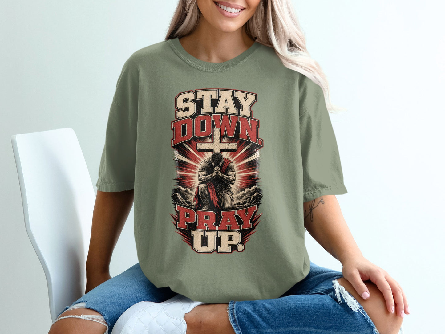 T-shirt with "Stay Down Pray Up" text, a kneeling figure, and a cross.