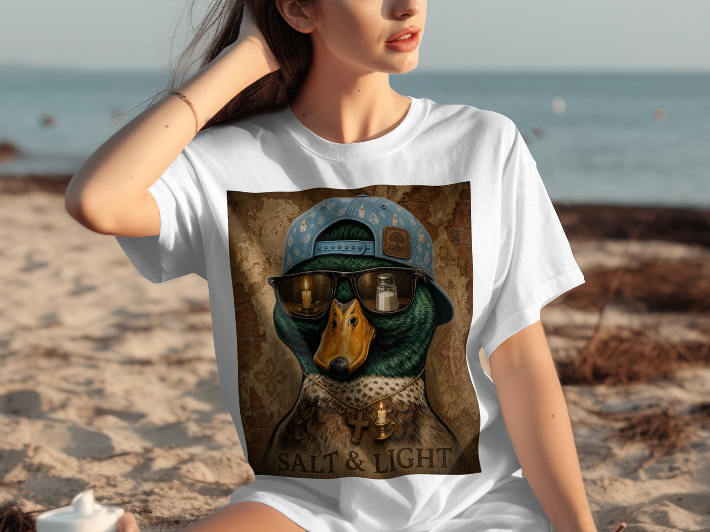 T-shirt graphic of a duck wearing sunglasses, a backwards cap, and a necklace with text "SALT & LIGHT".