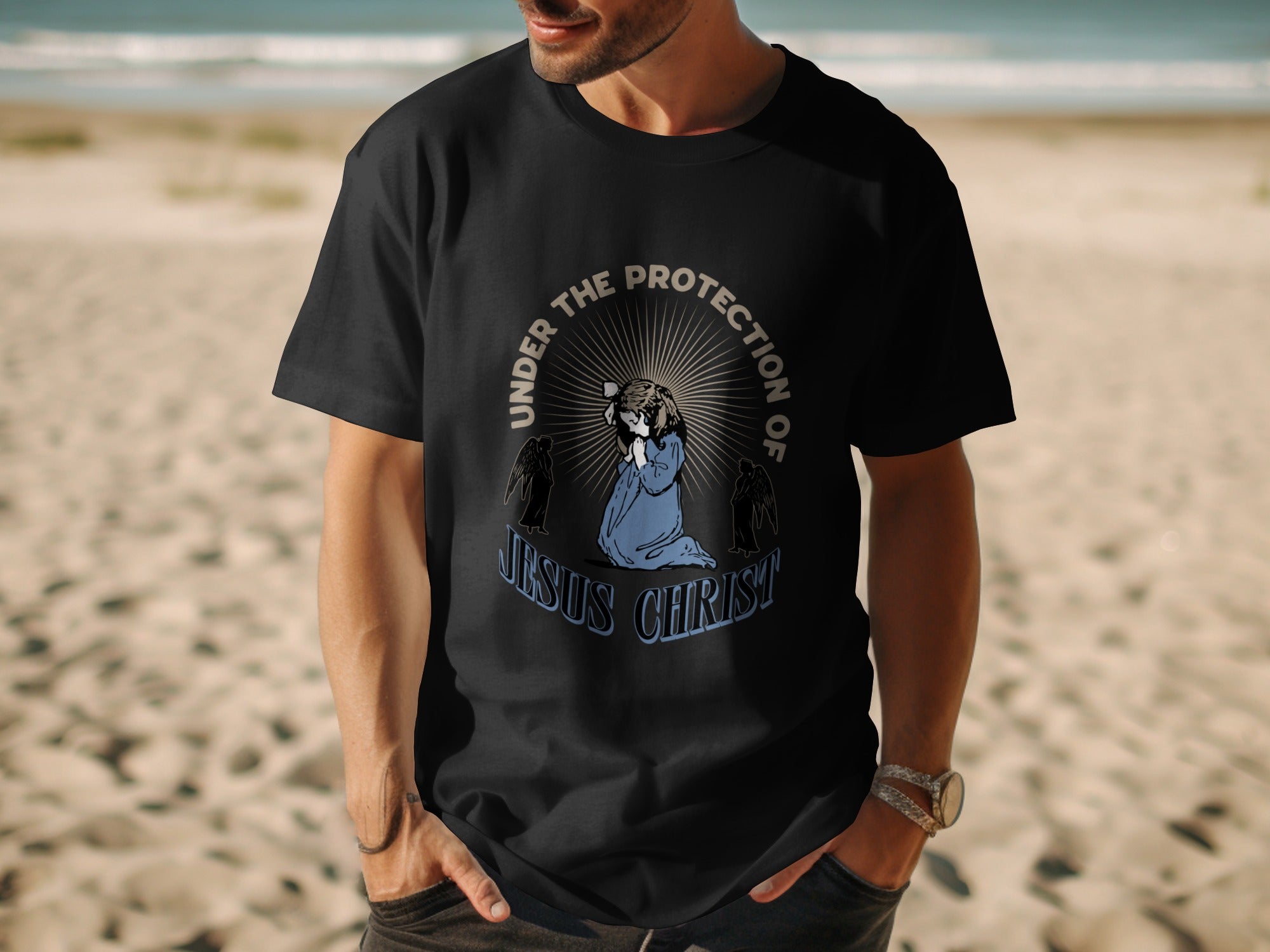 Black t-shirt featuring praying figure with "Under the Protection of Jesus Christ" text.