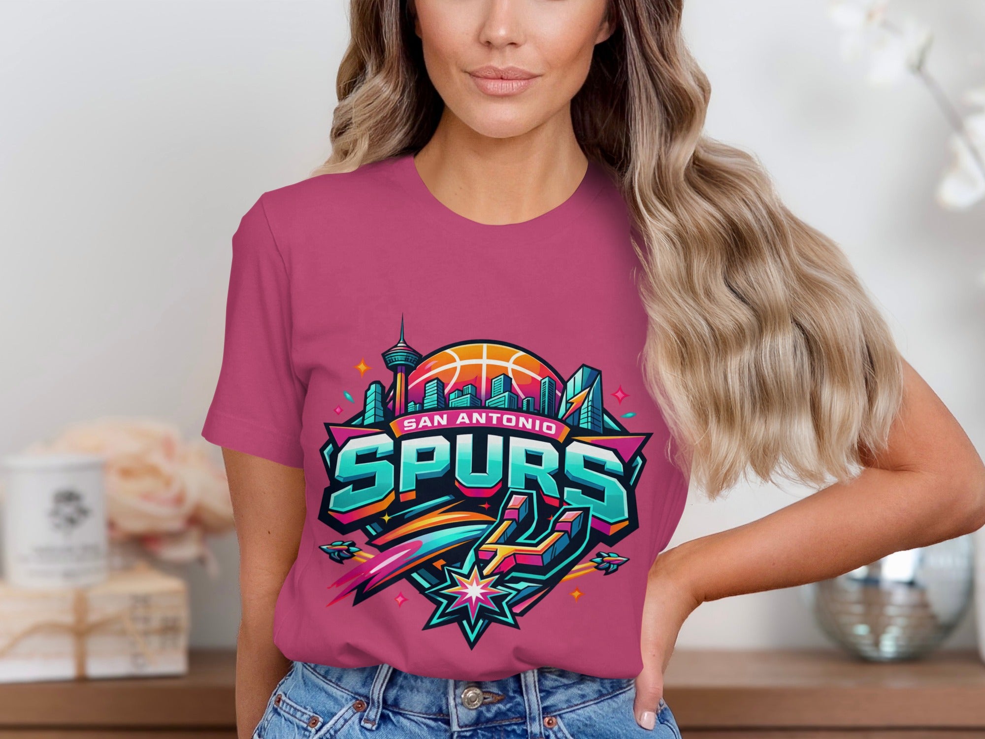 Pink t-shirt with San Antonio Spurs logo featuring city skyline and basketball.