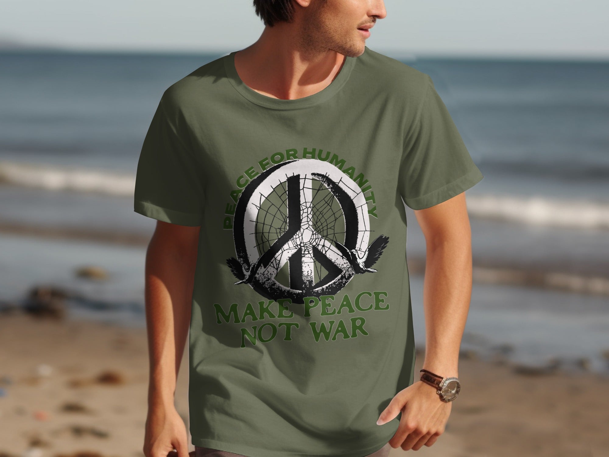 Olive green t-shirt with peace symbol, two birds, and text "PEACE FOR HUMANITY MAKE PEACE NOT WAR".