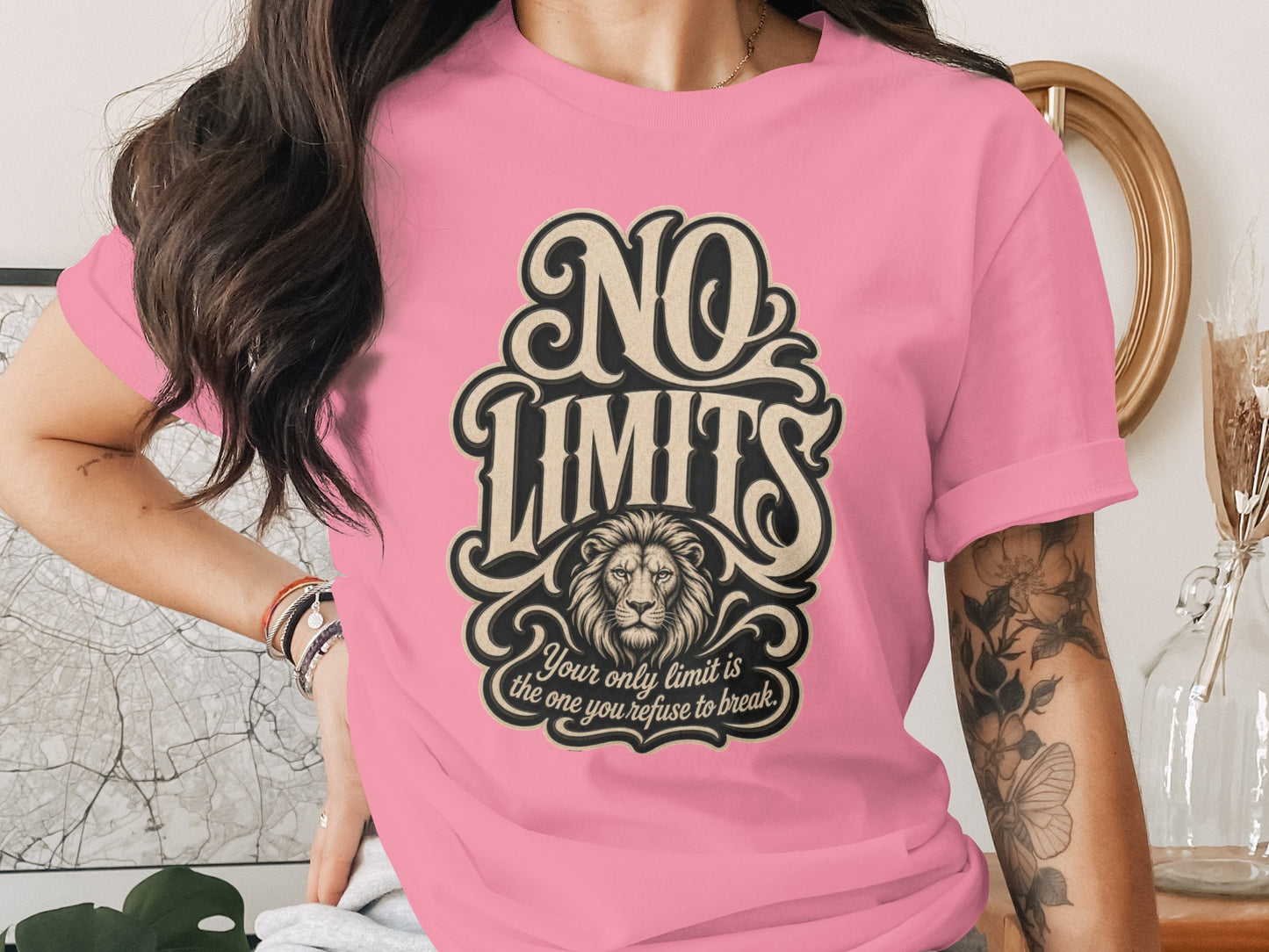 Pink t-shirt with "NO LIMITS" text, lion illustration, and motivational quote.