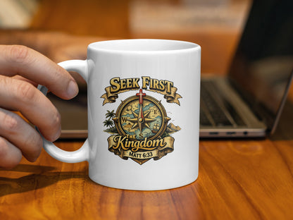 White mug with "Seek First The Kingdom Matt 6:33" and compass design.