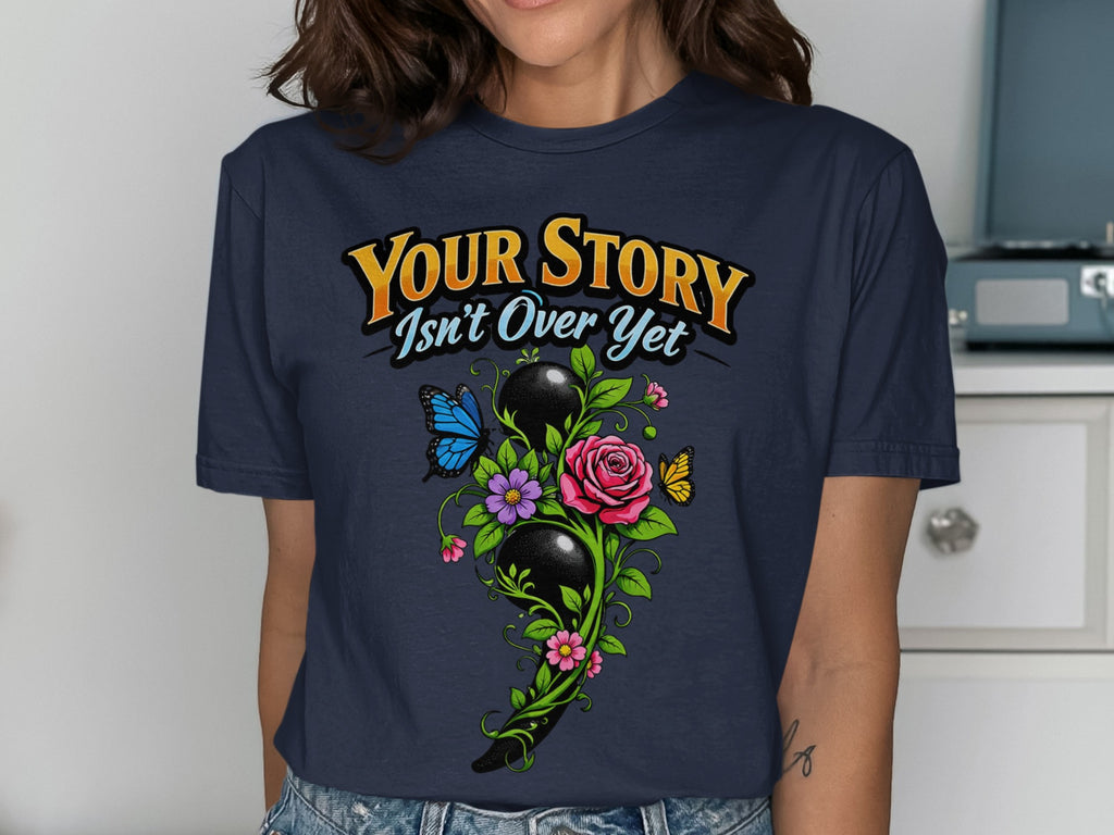 Navy t-shirt with "Your Story Isn't Over Yet" text and semicolon floral design.