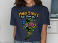Navy t-shirt with "Your Story Isn't Over Yet" text and semicolon floral design.