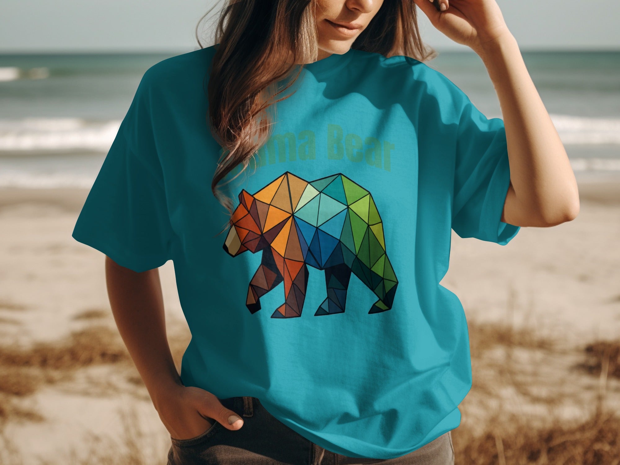 Turquoise t-shirt with geometric bear graphic and "nma Bear" text.