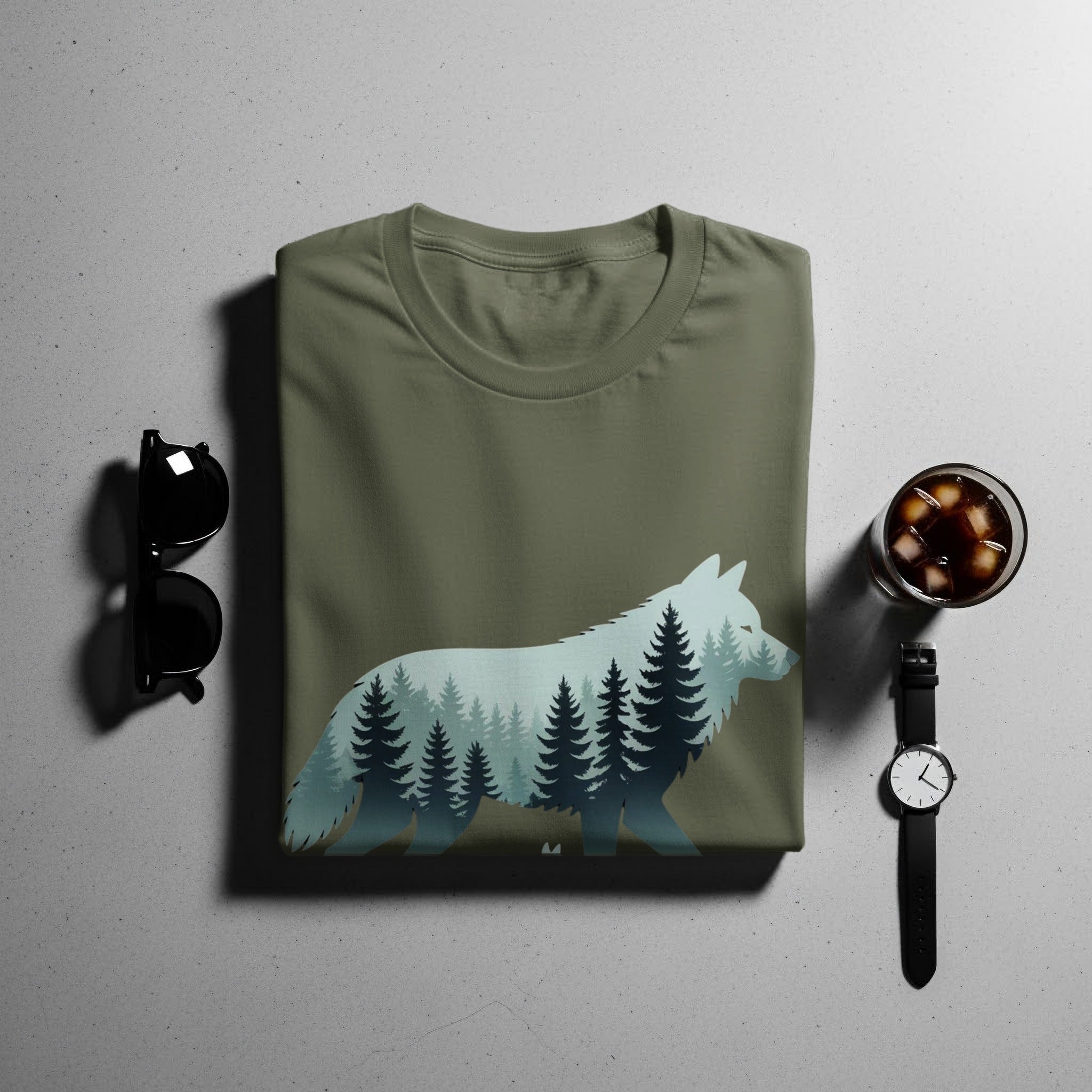 Olive green t-shirt with wolf and forest silhouette graphic.