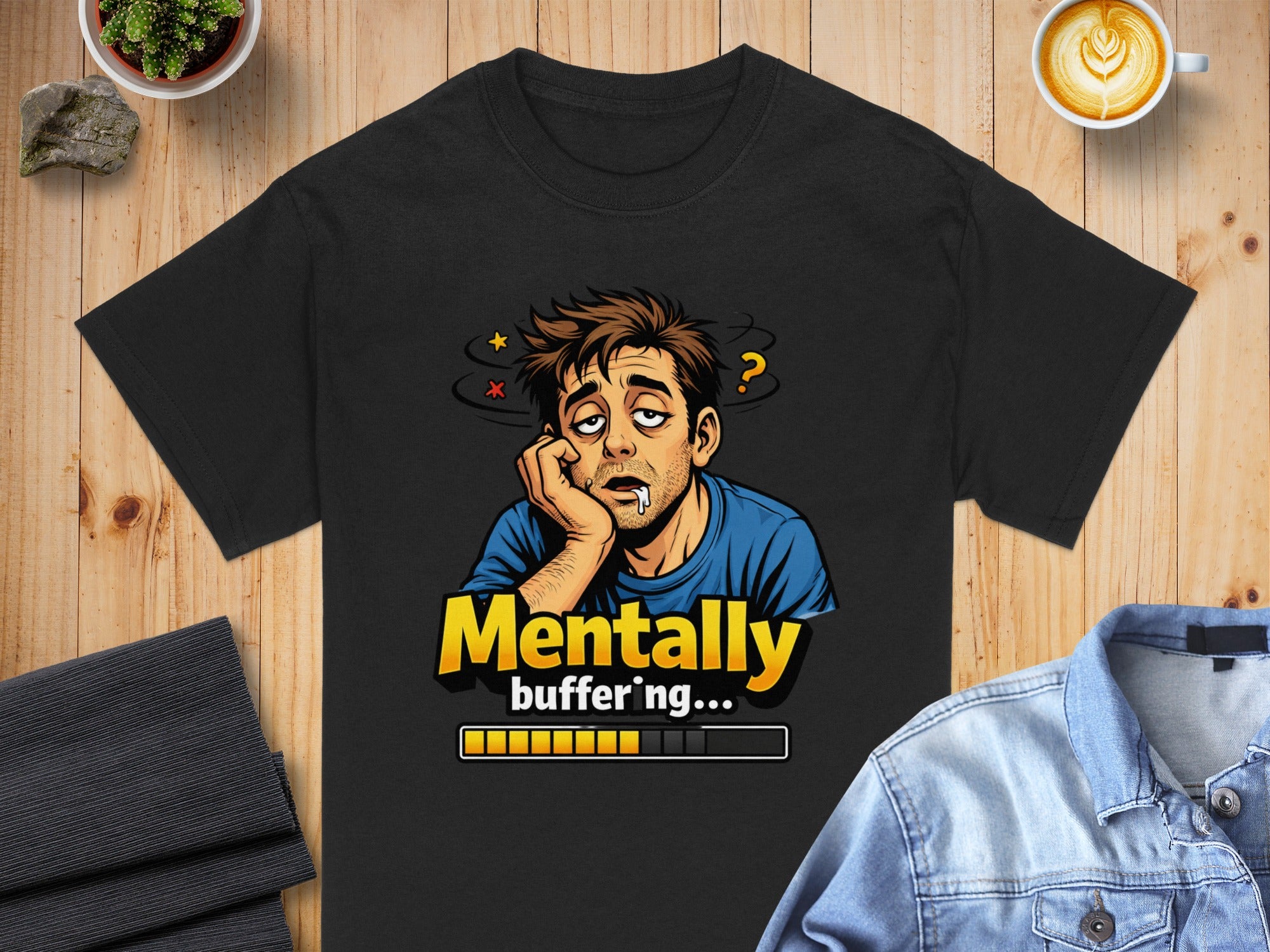 Black t-shirt with cartoon of tired man and text "Mentally buffering...".
