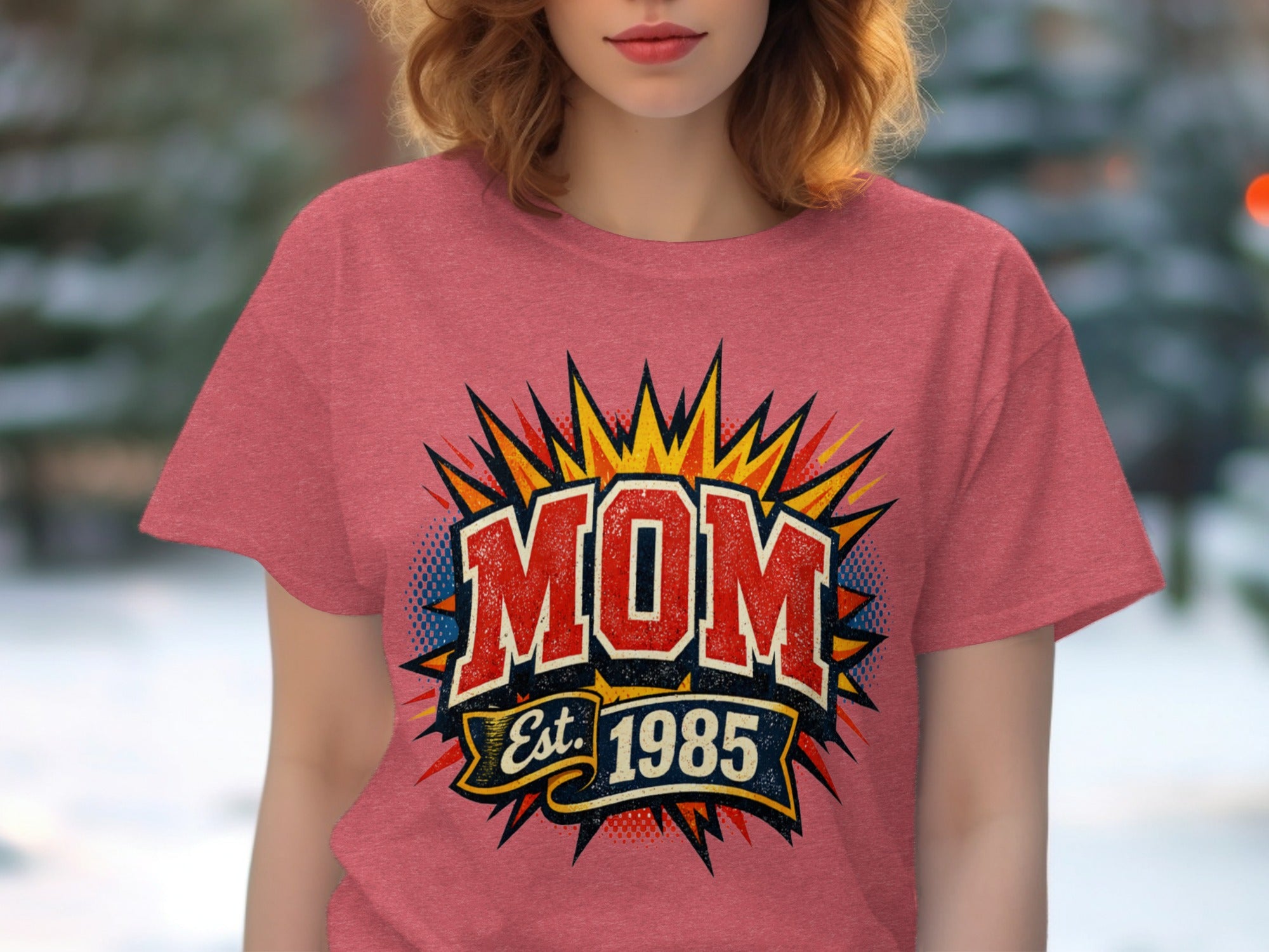 Graphic with "MOM Est. 1985" in bold vintage comic style on a pink t-shirt.