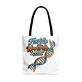 White tote bag with "Fearfully & Wonderfully Made" text and DNA graphic.
