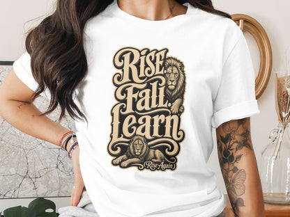 White t-shirt with "Rise Fall Learn" text and lions, with a smaller "Rise Again" subtitle.