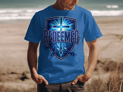 Blue t-shirt with "Redeemed" text and a cross on a shield with broken chains.