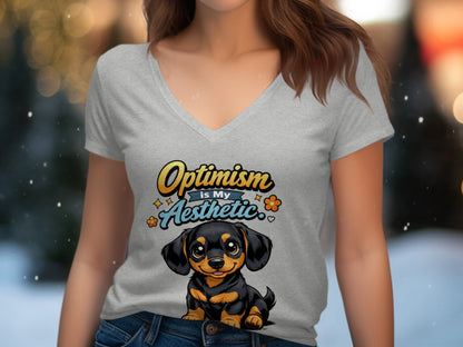Gray v-neck t-shirt with a cartoon dachshund and "Optimism is My Aesthetic" text.
