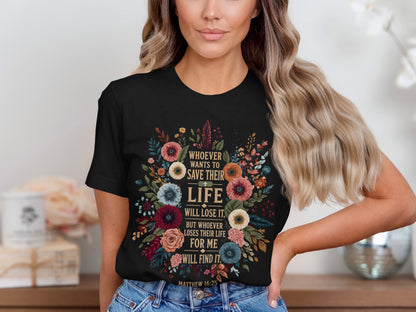 Black t-shirt with floral design and Bible verse "Whoever wants to save their life will lose it."
