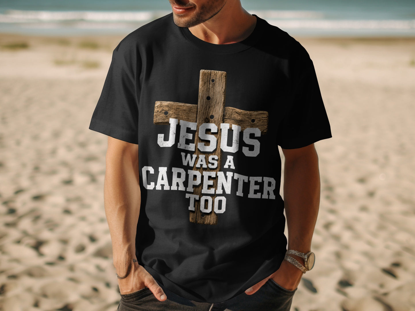 Black t-shirt with a distressed wooden cross and text "JESUS WAS A CARPENTER TOO".