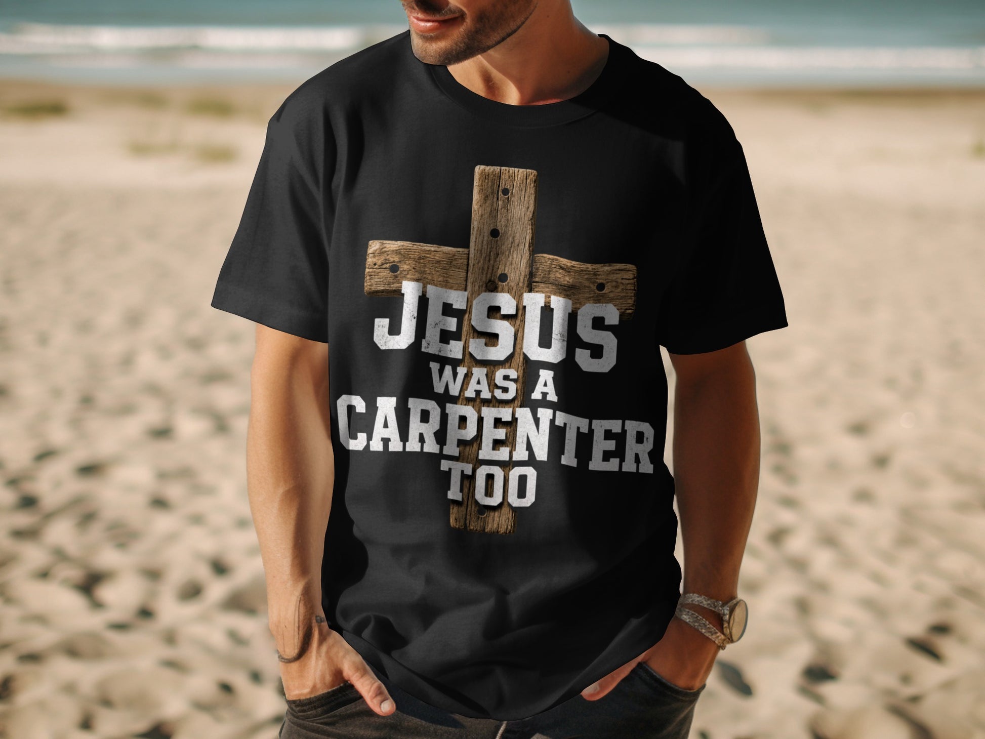 Black t-shirt with a distressed wooden cross and text "JESUS WAS A CARPENTER TOO".