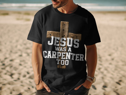 Black t-shirt with a distressed wooden cross and text "JESUS WAS A CARPENTER TOO".