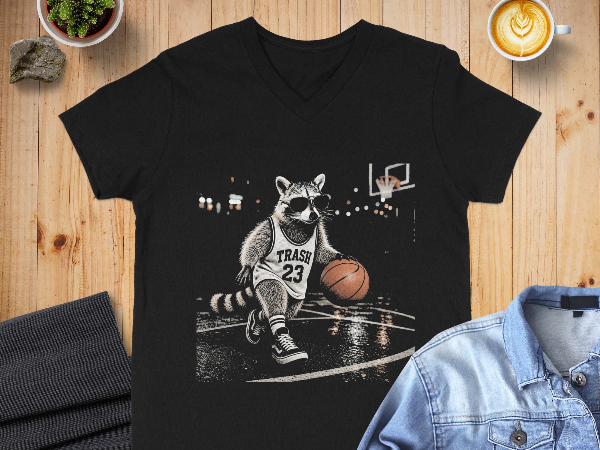 Black t-shirt with raccoon in sunglasses playing basketball, text "TRASH 23".