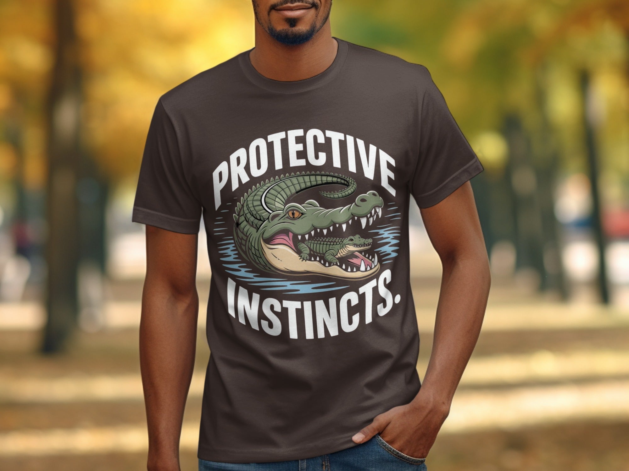 Brown t-shirt with alligators and text "PROTECTIVE INSTINCTS."