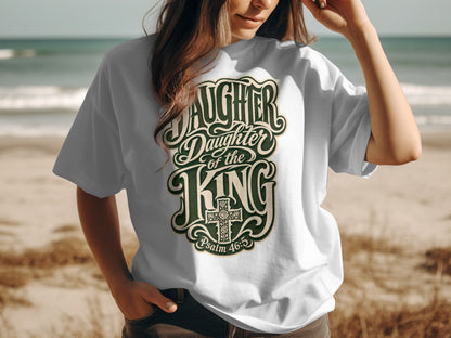 White t-shirt with "Daughter of the King" text and a cross.