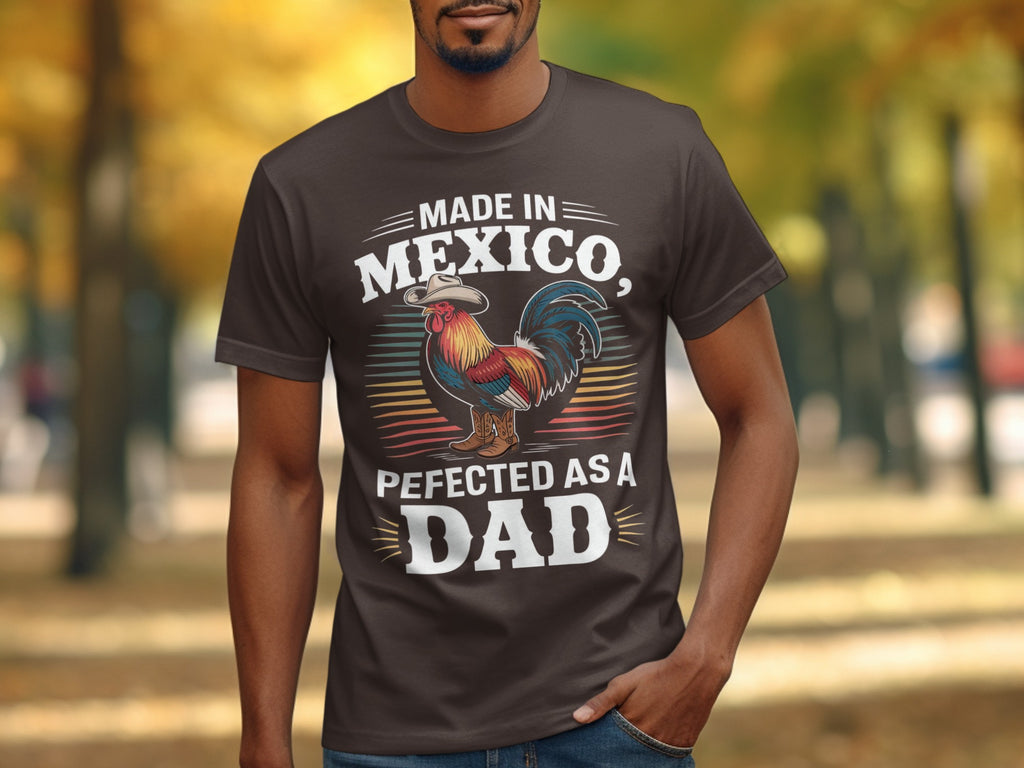 Brown t-shirt with text "Made in Mexico, Perfecyed as a Dad" and a rooster illustration.