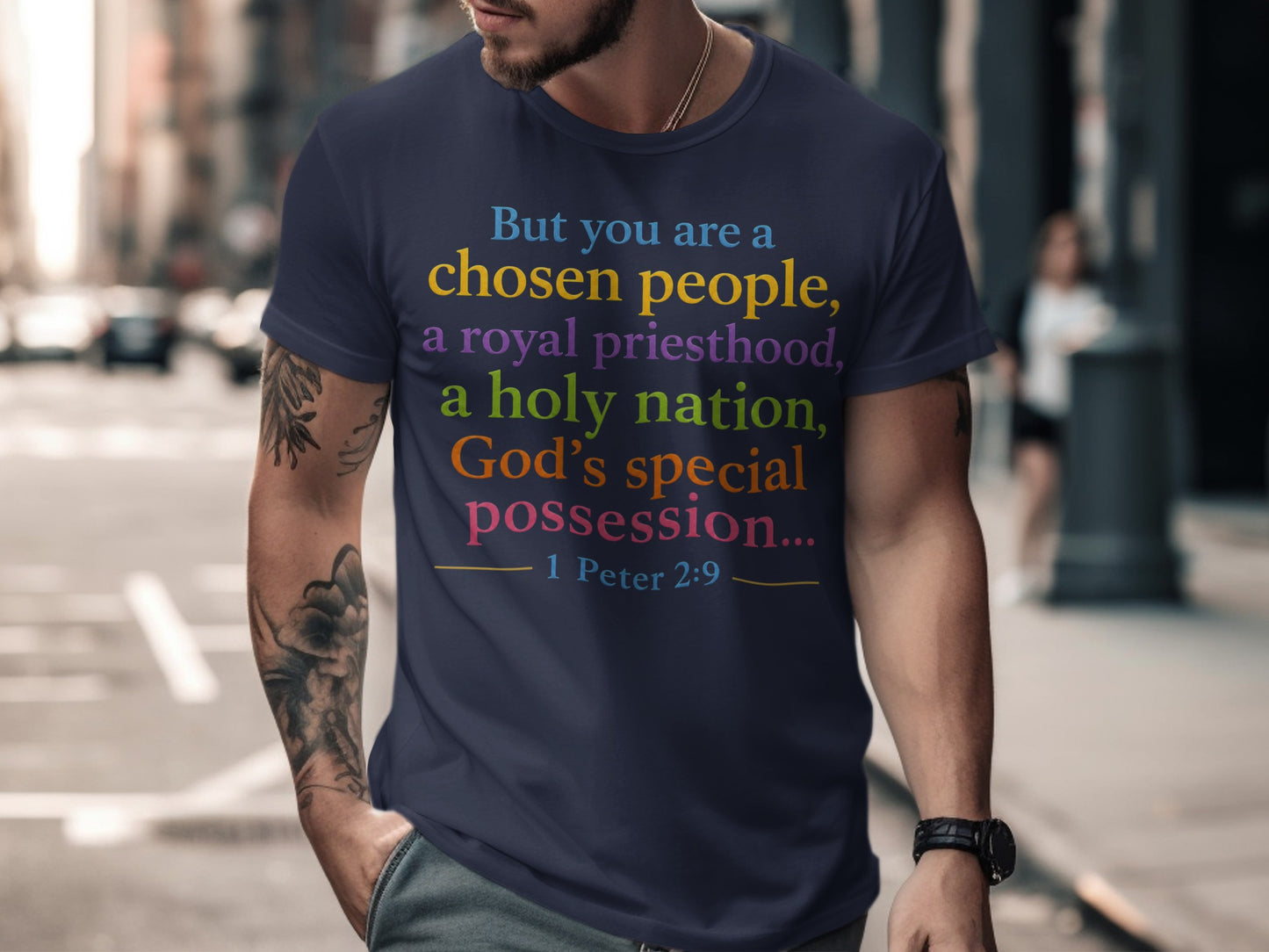 Dark blue t-shirt with text from 1 Peter 2:9 in rainbow colors.