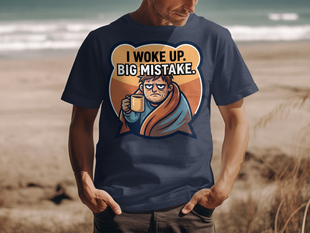 Dark t-shirt with cartoon graphic of man wrapped in blanket holding coffee cup with text: I WOKE UP. BIG MISTAKE.