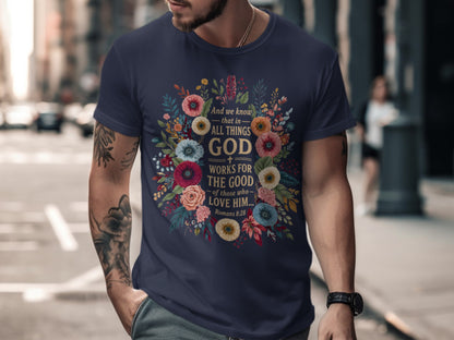 Navy t-shirt with floral wreath and "God works for the good" text.