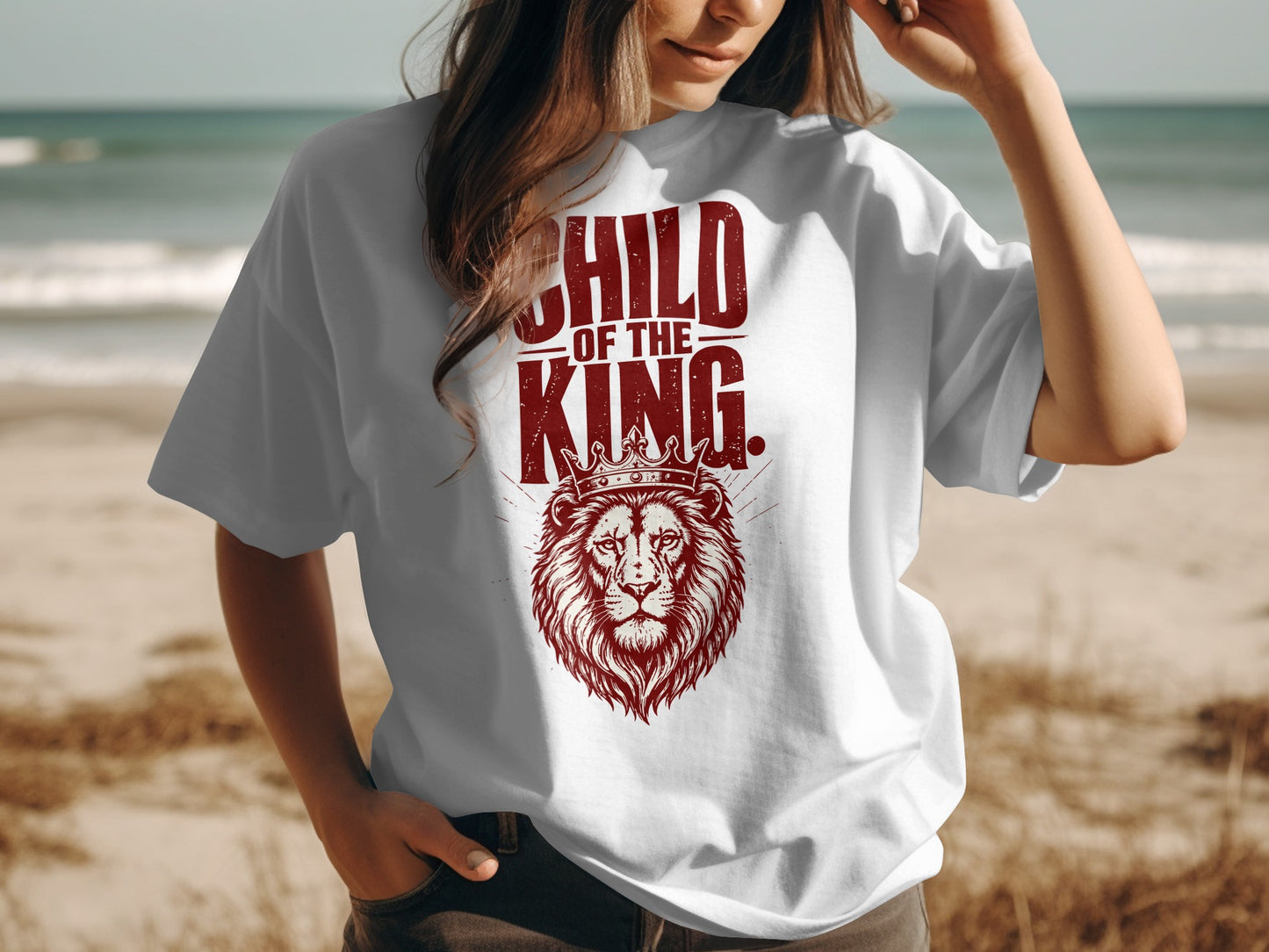 White t-shirt with red text "CHILD OF THE KING" and a lion wearing a crown.