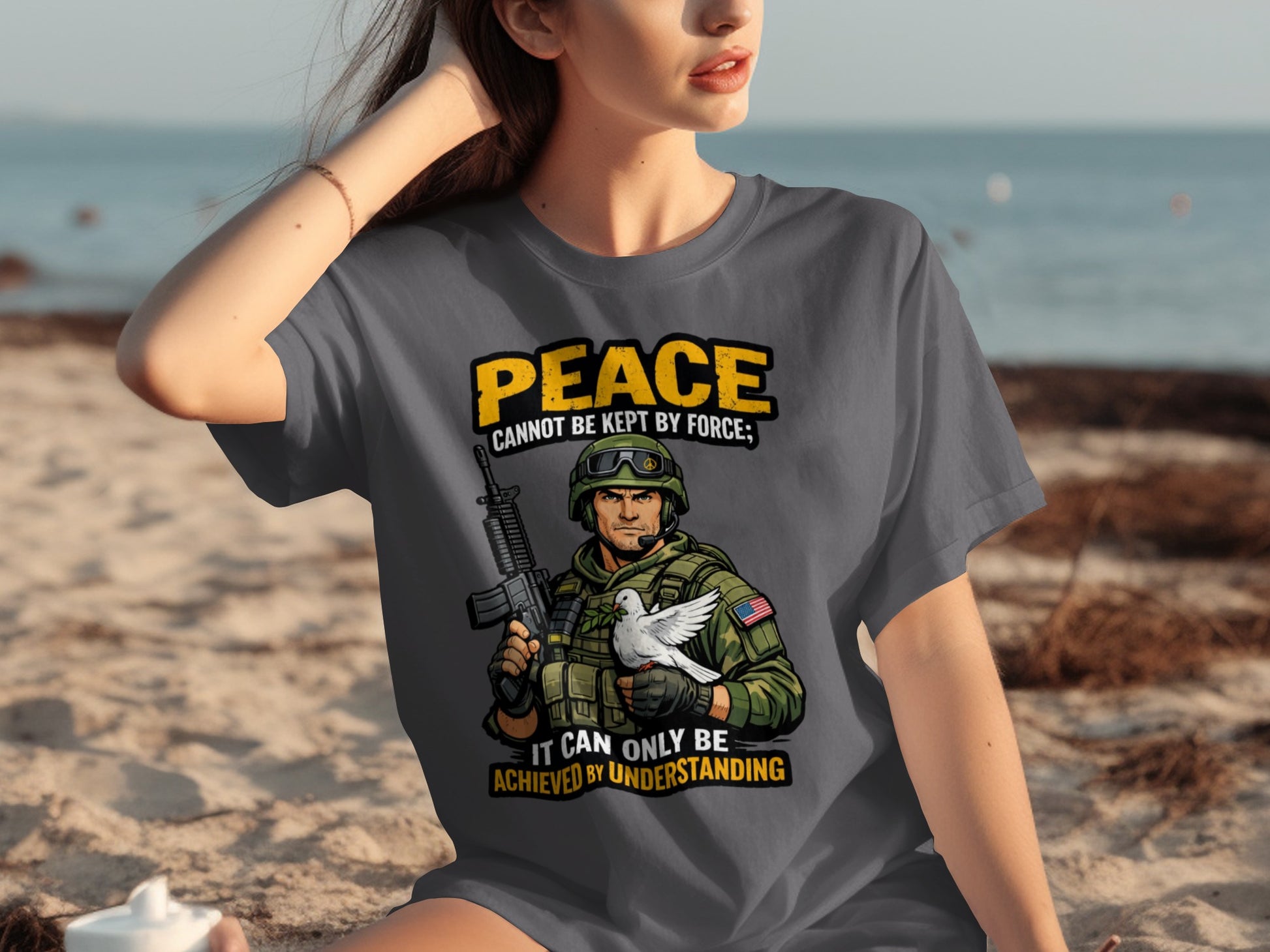 Gray t-shirt with a soldier holding a rifle and a dove, text says "Peace cannot be kept by force; It can only be achieved by understanding."